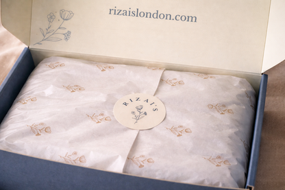 Rizai's gift box with 'rizaislondon.com' branding on a beige background