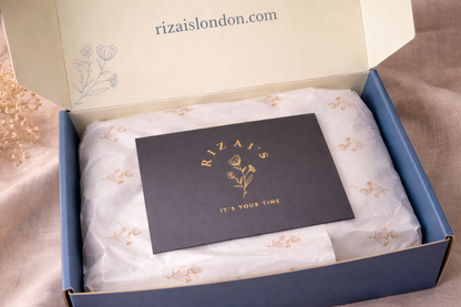 Gift box with a card inside, featuring Rizai's branding.